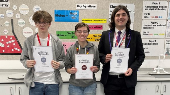 Three Chemistry students holding up their certificates.